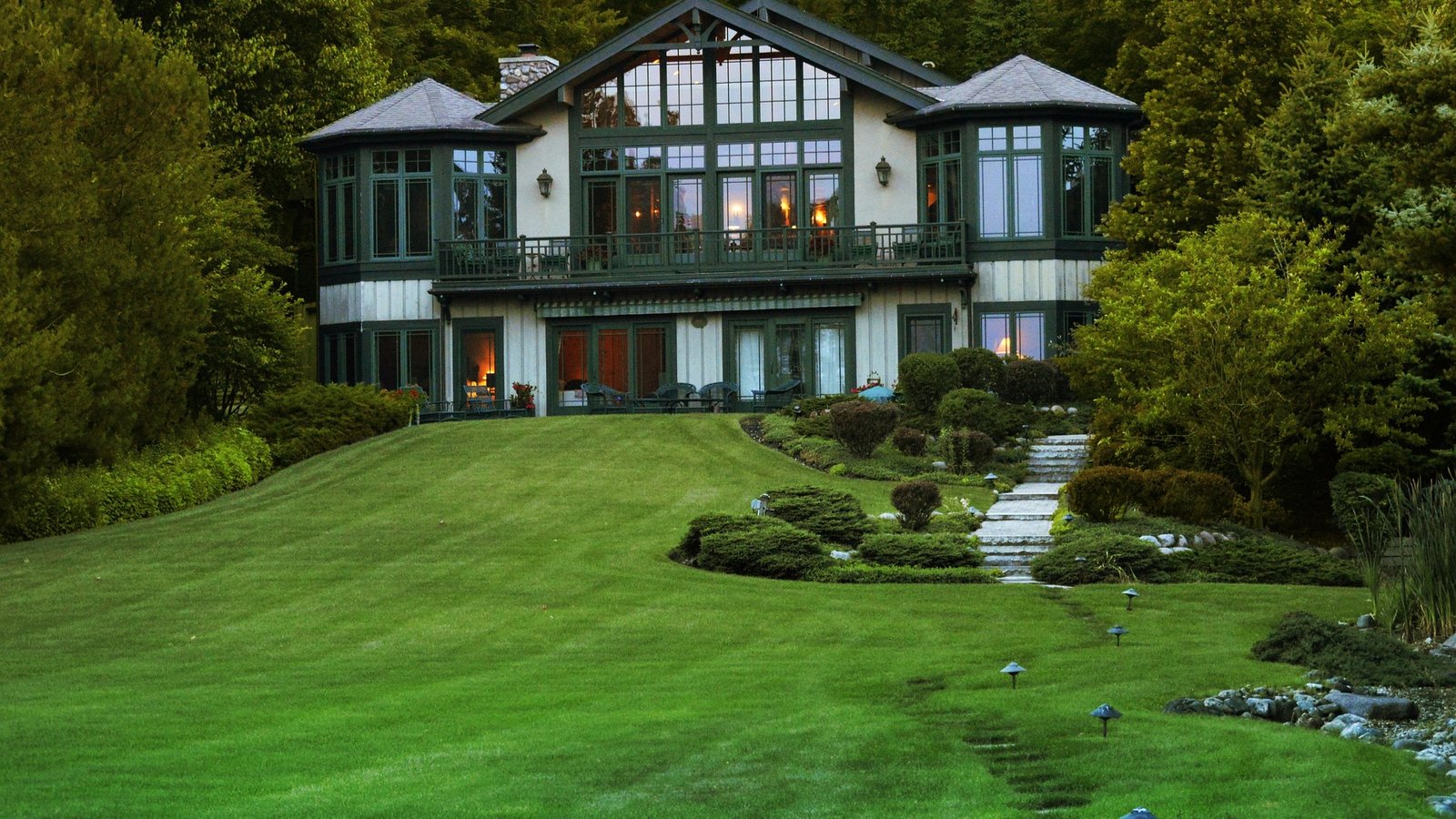 Manicured lawn and landscaped grounds of a large home